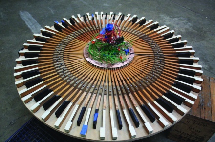 This piece reconfigures the well known solo instrument into a circular and group playing device. All materials were salvaged from the San Francisco dump including a working ibook computer, upright piano parts and a dell computer keyboard micro-controller. (Photo credit: Micah Gibson)