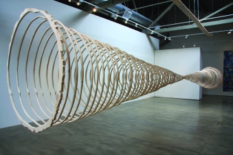This piece represents the cross sections of two trees, a familiar reference to nature’s clock and a dramatic visualization to time. This large-scale installation illustrates that the life-span of a tree is measured in centuries, and by inference, reminds us that human life is most often measured in decades. In a fast-paced, short-attention-span culture, this vivid reminder gives us pause. The “clocks” also reference Felix Gonzalez Torres Untitled (Perfect Lovers) that is comprised of two synchronized clocks that inevitably become out of synch. Similarly, my piece serves as a symbol of time’s inexorable flow. (Photo credit: Tammy Rae Carland)